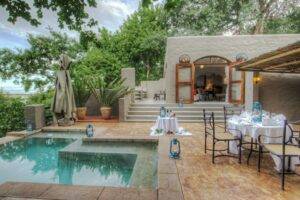 dining courtyard and swimming pool at Chobe Game Lodge