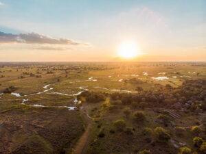 view of Camp Okavango and the sunset in the distance