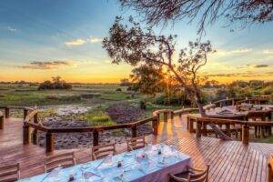 guest deck area with dining tables set at Camp Okavango