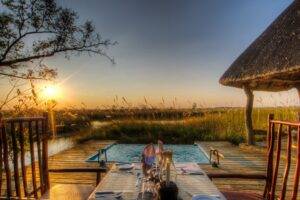Outdoor swimming pool area at Camp Xakanaxa