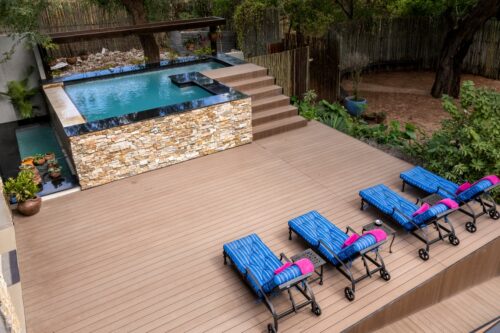 Outdoor swimming area with sunbeds at Chobe River Lodge