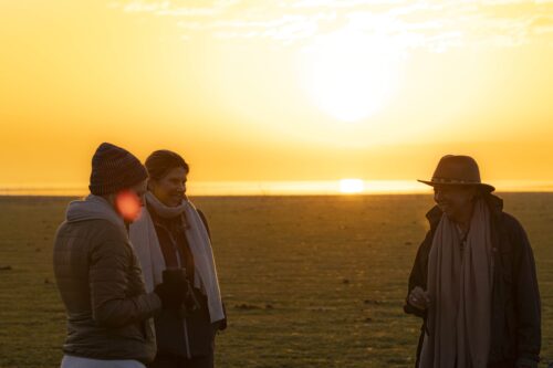 Guests watching a safari sunset on the plains of Gorongosa National Park