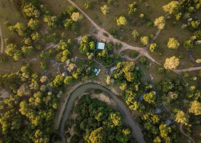 Aerial view of Muzimu Tented Camp nestled among woodlands in Gorongosa National Park