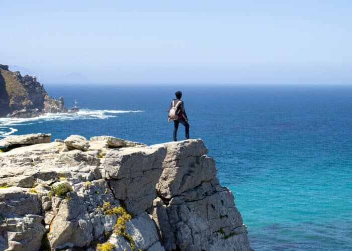 A man standing on the mountain at Cape Point in South Africa