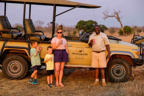 Family on a game drive with guide at Honeyguide Khoka Moya Camp in Manyeleti