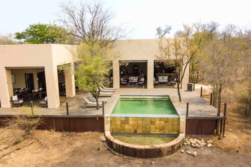 Main lodge building and pool area at Honeyguide Mantobeni Camp in Manyeleti Game Reserve